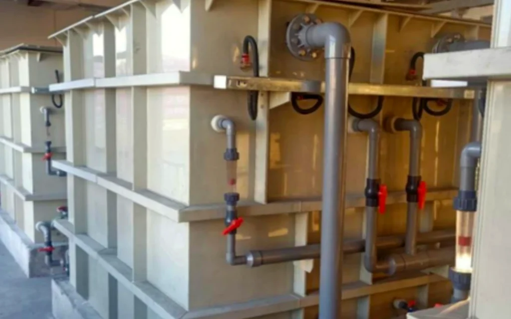 Pulp and Paper Industry Wastewater Treatment 4 Motiva STF Series electrochemical treatment tanks, piping, valves, and flow meters in an equipment area